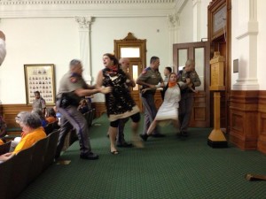 A protestor is forcibly removed from the gallery during HB2 proceedings. Photo by Melissa Conway, provided by Texas Right to Life.