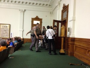 A protestor is forcibly removed from the gallery during HB2 proceedings. Photo by Melissa Conway, provided by Texas Right to Life. 