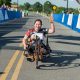 Sen. Duckworth, who supports unlimited abortions for women, participates in a race using an adapted bike.