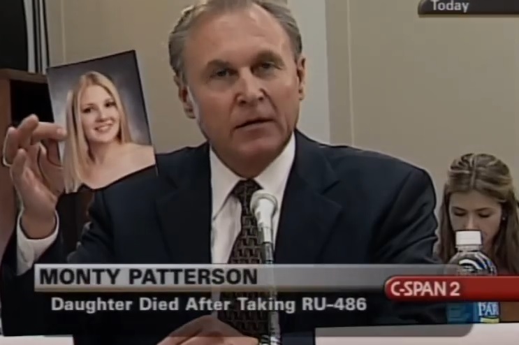 Image: Monte Patterson holds up pic of daughter dead after taking abortion pill at Planned Parenthood